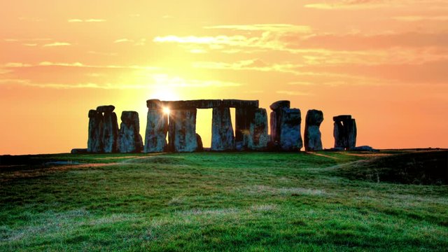 sunset over the stones of Stonehenge, the sun is moving rapidly across the sky, summer evening