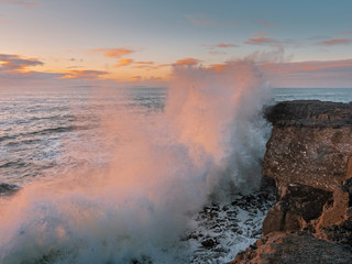 Wave crashes on rock coast line, Mini cliffs county Clare, Ireland, Concept power of Nature, Sunset time.
