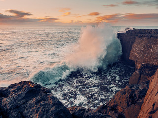 Fototapeta na wymiar Storm at Atlantic ocean, West coast of Ireland, county Clare, Wave hits rocks and created huge splash of water, Dangerous nature concept.
