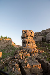The curb erosion from storms. To indicate the layers of soil and rock.