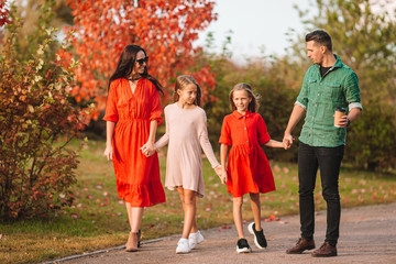 Obraz premium Portrait of happy family of four in autumn