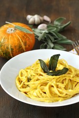 pasta spaghetti with pumpkin-cream sauce with sage and chips of sage leaves. autumn dish.