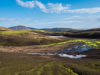 Fototapeta na wymiar Colorful Rhyolit mountain panorma with snow fiields and multicolored volcanos in Landmannalaugar area of Fjallabak Nature Reserve in Highlands region of Iceland