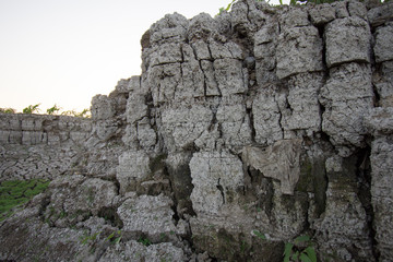 The curb erosion from storms. To indicate the layers of soil and rock.