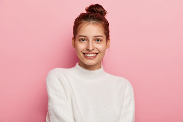 Beauty and facial expressions concept. Tender feminine woman with blue eyes, smiles pleasantly, has...