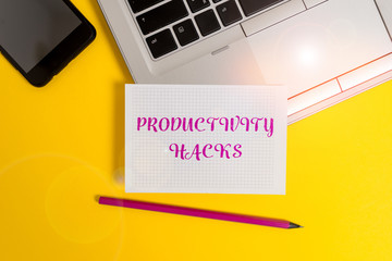 Text sign showing Productivity Hacks. Business photo text tricks that you get more done in the same amount of time Metallic laptop pencil squared paper sheet smartphone colored background