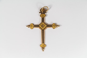 Fototapeta na wymiar Traditional catholic cross pendant made in gold