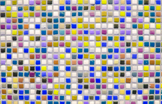 Bright multi-colored tile. Square color ceramic mosaic. Color optimistic background. Building decorative design concept. Place for text, lettering. Copy space. Selective focus image.