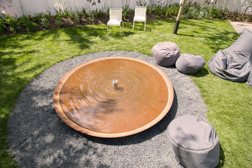 Round water basin in centre of garden