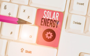 Handwriting text Solar Energy. Conceptual photo radiation from the Sun capable of producing heat or electricity White pc keyboard with empty note paper above white background key copy space
