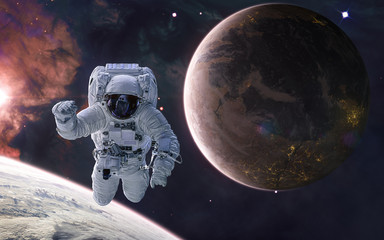 Obraz na płótnie Canvas Astronaut on background of a colonized planet. Planets of deep space in warm starlight. Science fiction. Elements of this image furnished by NASA