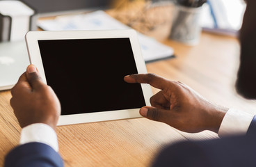 Cropped image of businessman touching blank digital tablet screen