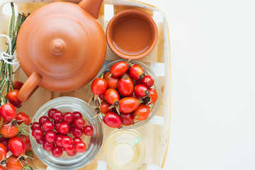 herbal tea with rose hips isolated on white, Medicinal plants and herbs composition	