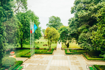a green summer park with flags