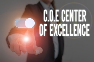 Word writing text Coe Center Of Excellence. Business photo showcasing being alpha leader in your position Achieve Woman wear formal work suit presenting presentation using smart device