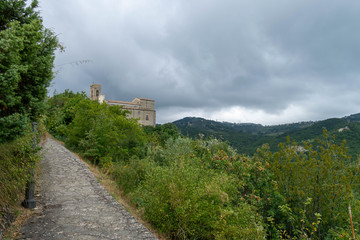 Fototapeta na wymiar Stone road towards an ancient medieval church