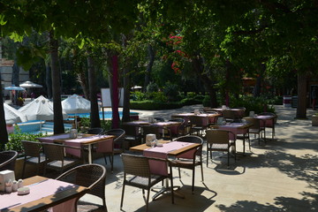 Obraz na płótnie Canvas Table and chairs by the pool