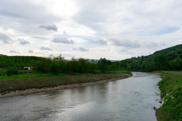 Panorama with calm river and lush banks. The river that flows and inspires calm