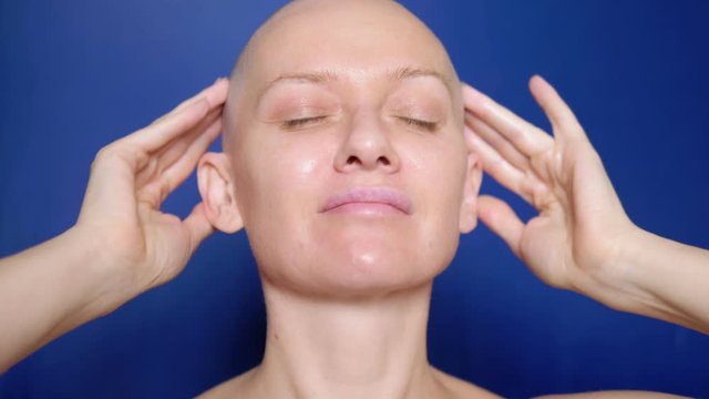 satisfied bald woman rubs hair growth agent in her head. Weird People Adventure Concept