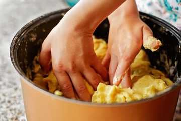 Kid mixing sweet yeast dough. Child helping mom to bake pastry. Hands of little chef preparing treat. Little baker (toddler cook) making batter. Happy family baking. Children learning and development