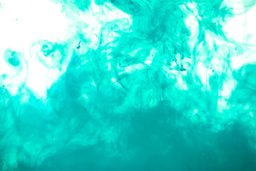 colorful blue ink isolated on white background, cloud of paint swirling in water, liquid dynamic abstract background