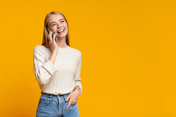 Portrait of cheerful teen girl talking on phone