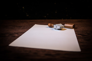 Close up view of rubber date stamper on wooden table with dark toned foggy background.