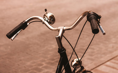 ANCIENT BIKE HANDLEBAR PARKED IN A STREET OF MADRID. VINTAGE PHOTOGRAPHY.