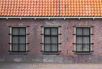 Barred windows in a 19th century prison complex
