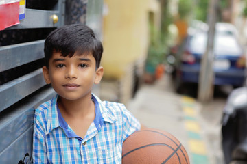 Portrait of Indian little boy with Basketball