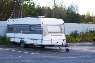 Movable property. Old abandoned motor mobile home for traveling, trailer, caravan parked in a parking lot.