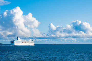 White cruise ship sailing on a blue sea. Sea voyage by ship. Sea cruise in Europe. Ferry in the...