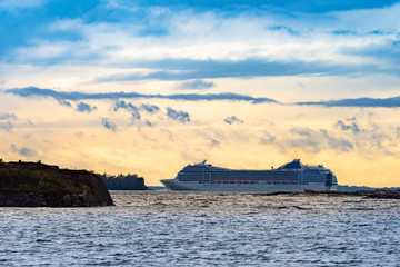 White ferry against the sunset. Travel to Scandinavia by ferry. Sea cruise. Journey to the Baltic...