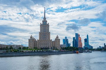 Fototapeta na wymiar Moscow. Russia. Different architectural styles in the capital of the Russian Federation. High-rise building of Stalin times. Moskva-city. Modern complex of skyscrapers. Boat trips on the river Moscow.