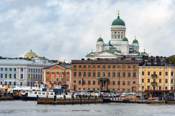 Fototapeta na wymiar Helsinki. Finland. Suomi. The cruise harbour. Cathedral Of St. Nicholas. Suurkirkko. Business card of Helsinki. Panorama of the capital of Finland on a cloudy day. Travelling to Scandinavia.