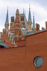 London's British Library facade with the St Pancras Renaissance Hotel towering out above it