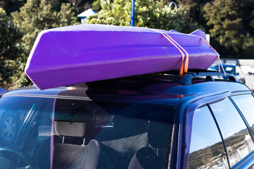 trip vacation tied kayak boat on top roof car in park