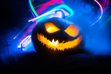 Halloween pumpkin smile and scary eyes for party night. Close up view of scary Halloween pumpkin...