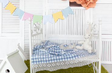 bright white children's room with a bed and a toy