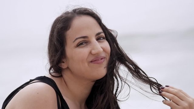 Beautiful and sexy girl spends a wonderful day at the beach in summer - slow motion shot