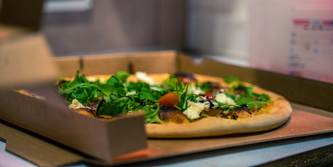 Pizza in its packaging, ready to be transported to the customer, worked pizza,