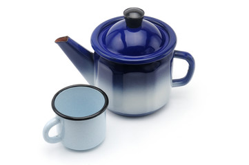 Vintage teapot in blue with a mug on a white background