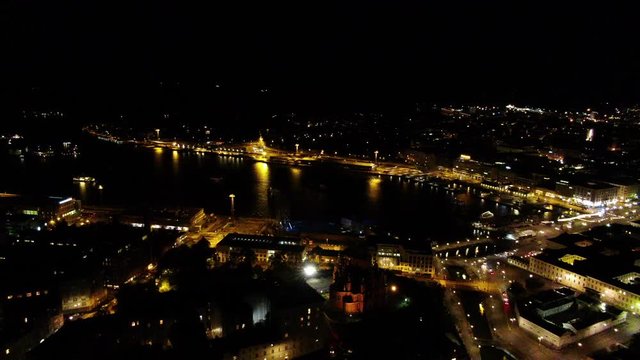 City Illumination. Flying over city lights in dark night. Aerial drone shot.