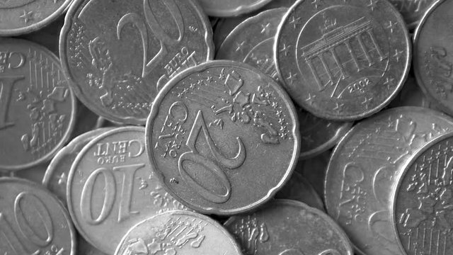 Close-up of A Rotating Heap of Used Golden Euro Coins, Black and White With Selected Focus