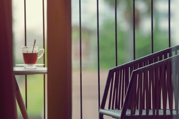 Hot black coffee in clear glass on the table at balcony. Morning cup of hot coffee on the table. soft focus.