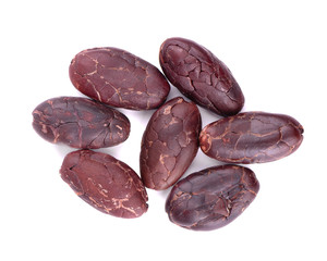 Peeled cacao beans, isolated on white background. Roasted and aromatic cocoa beans, natural chocolate. Top view.