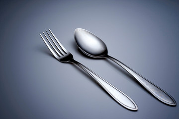 fork and spoon on dark background