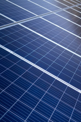 A solar panel in blue and yellow tones generating green electricity in a blue environment