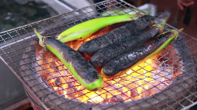 grilled eggplant on fire for Thai food cooking