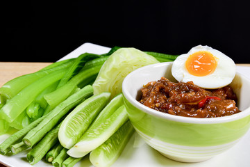 Naam phrik lohng reuua is made by frying sour-sweet and salty fermented shrimp paste chili sauce (nam prhrik kapi) together with a salty-sweet pork condiment. That is normally eaten with vegetables.